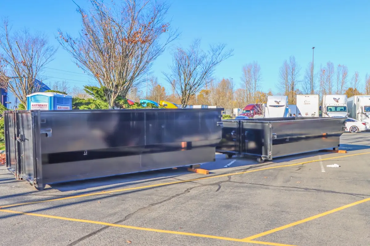 Professional dumpster rental service with roll-off container on residential driveway in Bixby